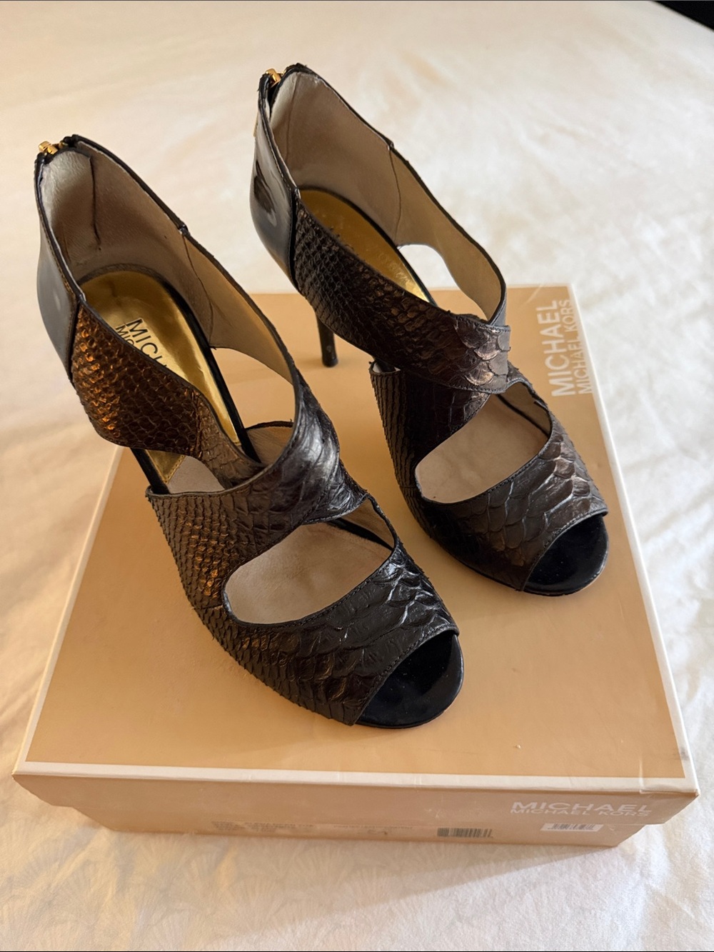Michael Kors black also shows some dk brown snake-Embossed Peep-Toe . Cutout Hee
